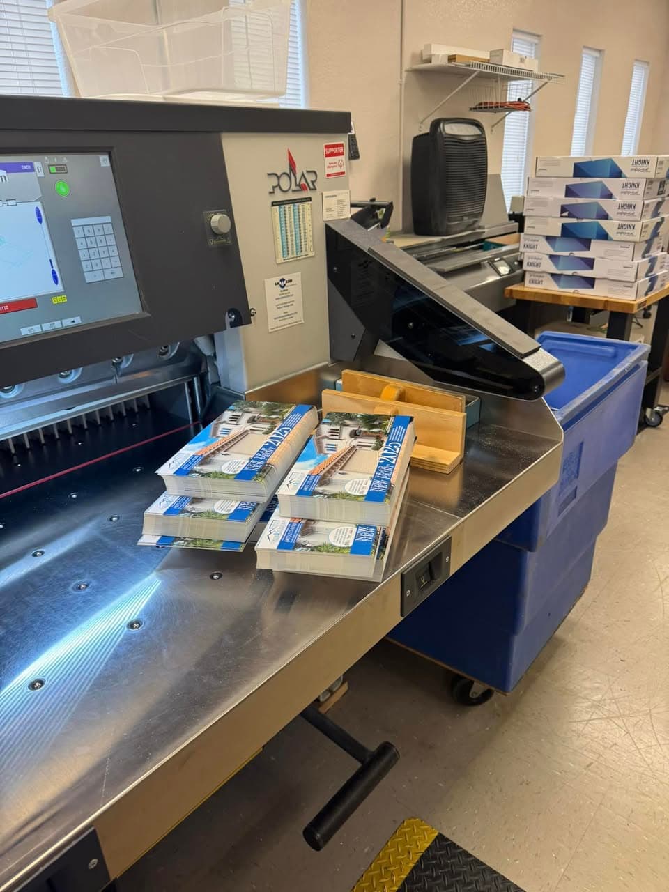 POLAR paper cutting machine trimming catalogs at Ranger Printing