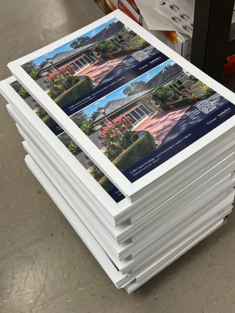 Stack of Sotheby's Premier real estate brochures fresh off the Ranger press